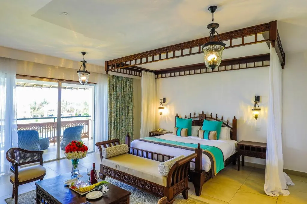Elegant room at Royal Zanzibar Beach Resort with canopy bed and garden or sea view